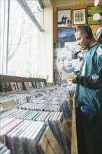 Teenage boy listening to headphones in a music store