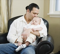 Asian father holding baby
