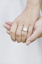 Close up of Asian woman's wedding ring