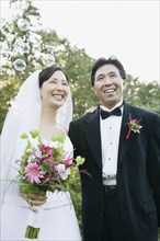 Asian newlyweds with bubbles