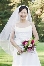 Asian bride holding bouquet