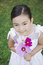 Mixed Race girl holding flowers