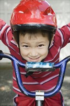Asian boy riding bicycle