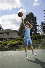 Asian boy playing basketball
