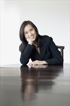 Japanese businesswoman smiling at table