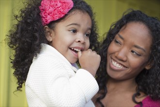 Mixed race mother and daughter smiling
