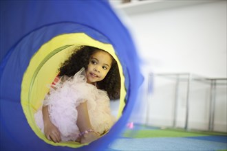 Mixed race girl playing in tube