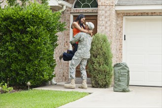 Solder returning home greeting excited wife