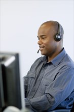 African American businessman working on computer in call center