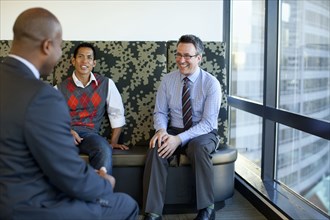 Businessmen talking together in office lobby