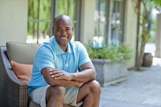 Smiling African American man sitting on patio