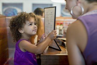 Mother and daughter ordering in restaurant