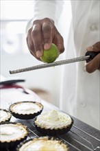 Black chef making key lime tart in restaurant