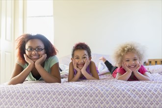 Mixed race sisters laying in bed