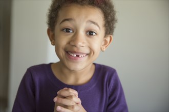 Mixed race girl with hands folded