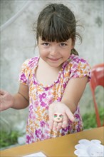 Caucasian girl holding painted rock