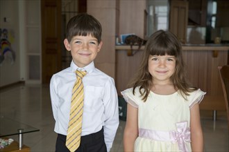 Caucasian children smiling in formal wear