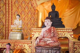 Ornate Buddha statues in temple