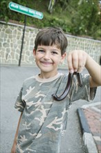 Caucasian boy holding millipede outdoors