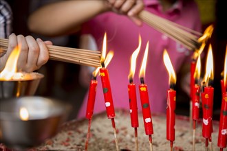 Close up of children lighting incense