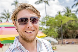 Caucasian man smiling on tropical beach
