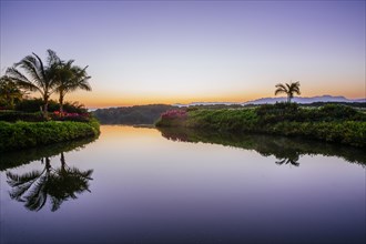 Sky reflected in still tropical lake