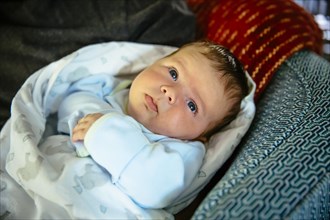 Caucasian baby boy wrapped in blanket