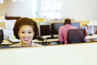 Businesswoman smiling at desk in office