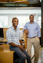 Black businessmen smiling in office