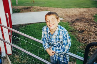 Caucasian boy smiling on farm