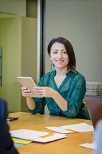 Businesswoman using digital tablet in office meeting