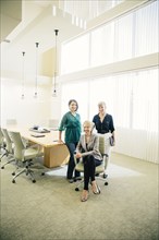 Businesswomen smiling in office meeting