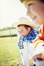 Caucasian children smiling on hay ride