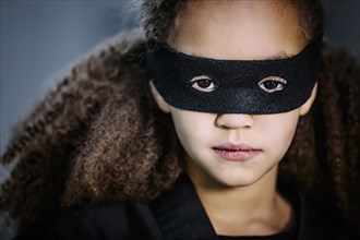 Close up of mixed race girl wearing mask