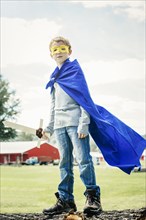 Caucasian boy wearing costume on farm