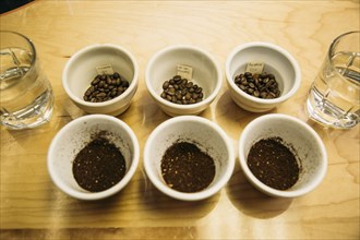 Variety of ground coffee beans in cups