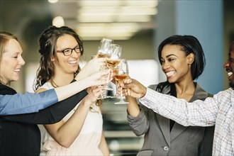 Business people toasting with wine in office
