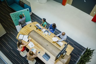 High angle view of business people working in office meeting