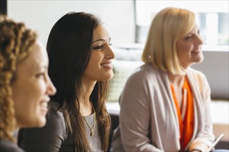 Businesswomen listening in office meeting