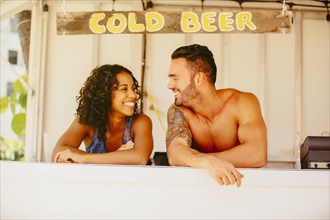 Couple smiling in beach shack