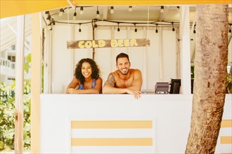Couple leaning in beach shack