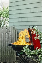 Fire burning on grill in backyard
