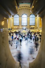 Blurred view of people in train station