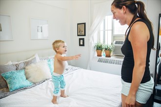 Mother and son talking in bedroom