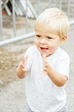 Close up of mixed race boy clapping outdoors