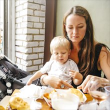 Mother and son eating in restaurant