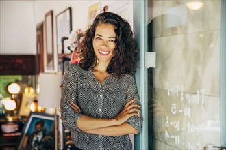 Mixed race entrepreneur standing in store