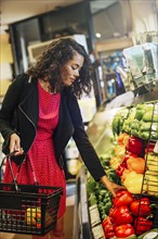 Mixed race woman shopping in grocery store