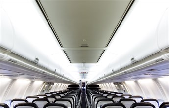 Empty chairs and compartments in airplane