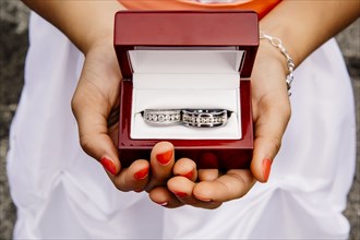 Mixed race girl holding wedding rings